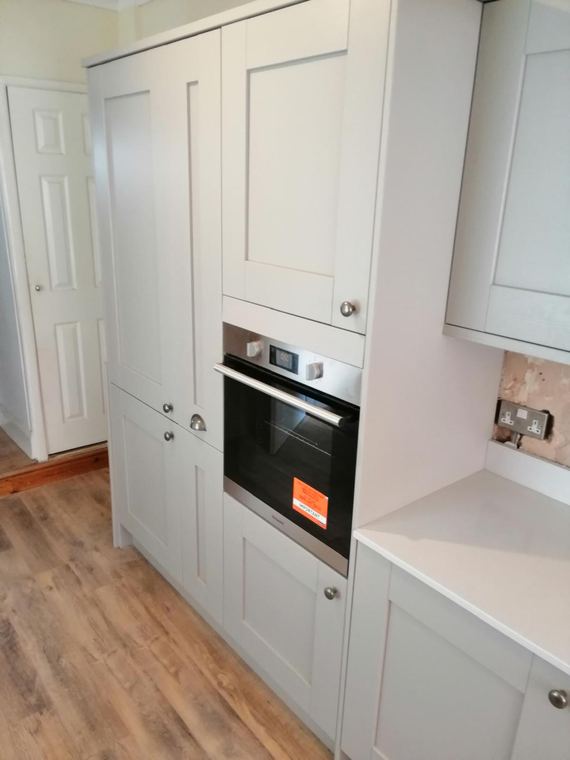 Full-height cabinetry housing a built-in oven