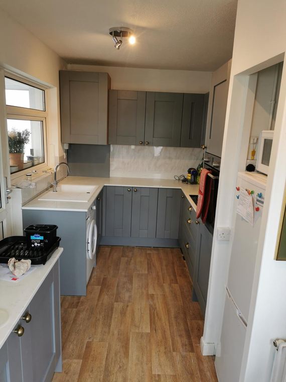 Grey shaker galley kitchen with a wood-effect floor
