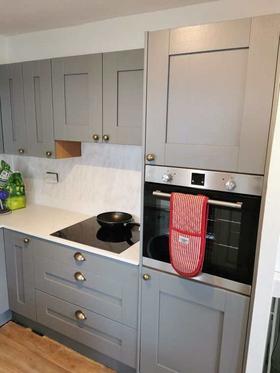Hob, oven and worktop in a grey shaker kitchen
