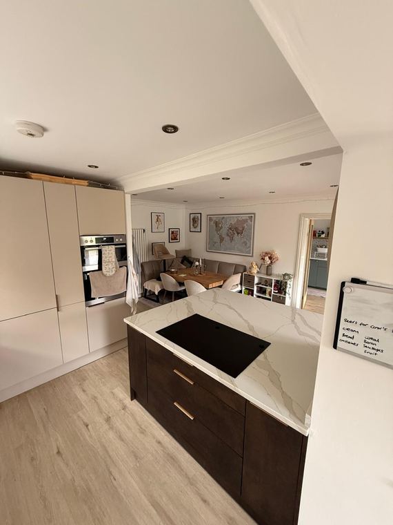 Dark timber island against pale wall units