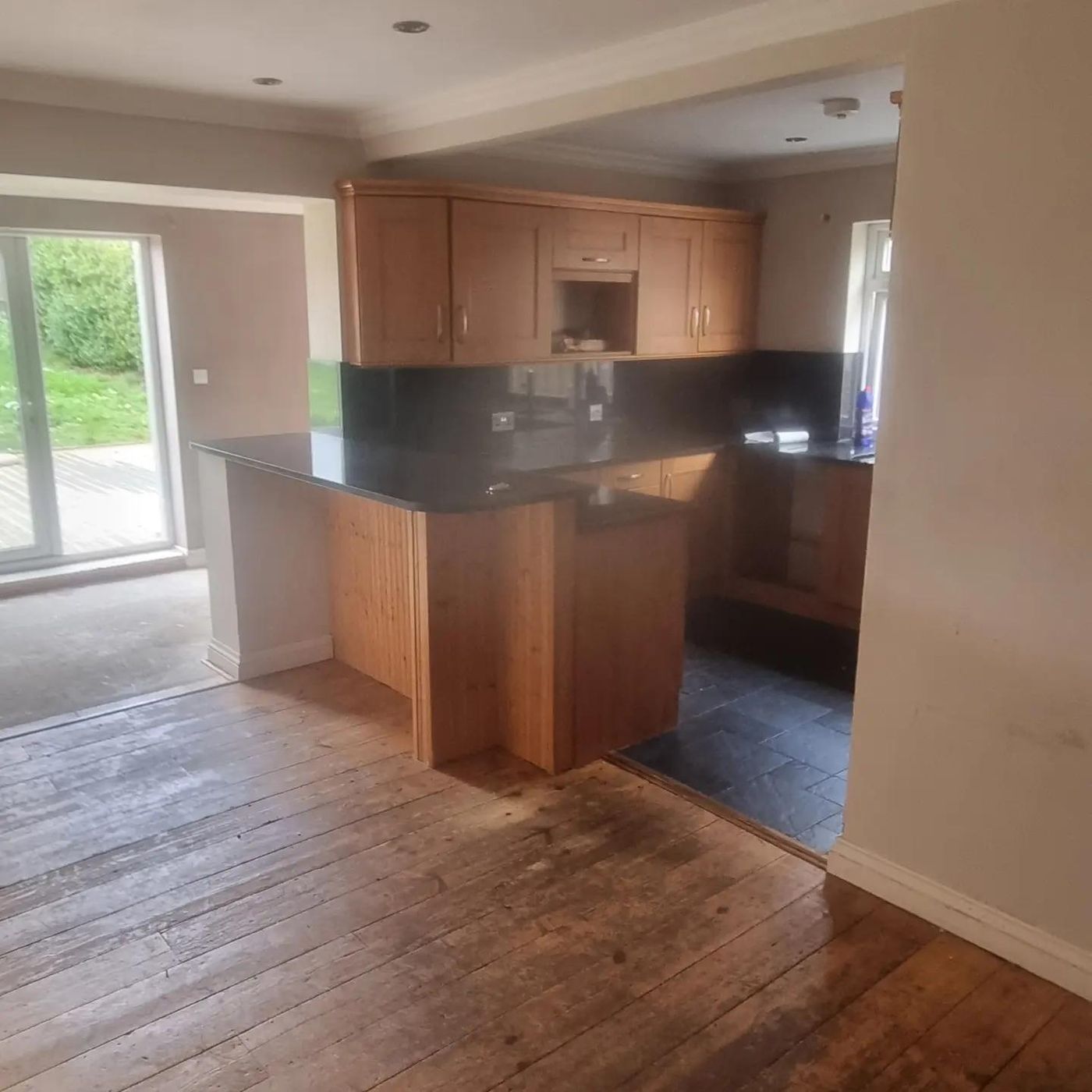 Original kitchen with beech units and a dark granite peninsula