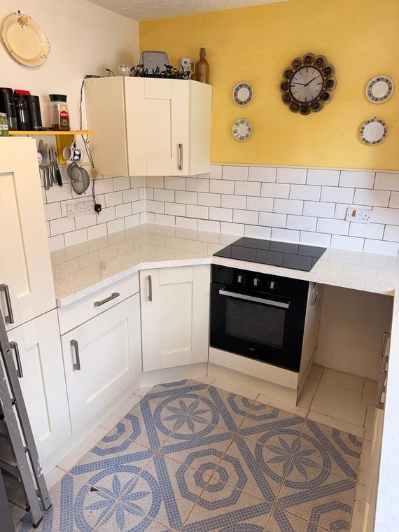 White kitchen with a patterned tile floor
