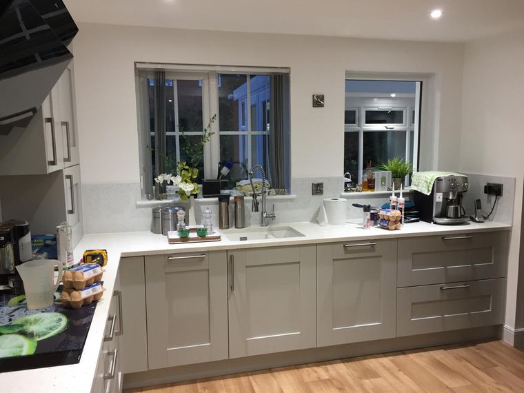 Sink run under a window with quartz worktops