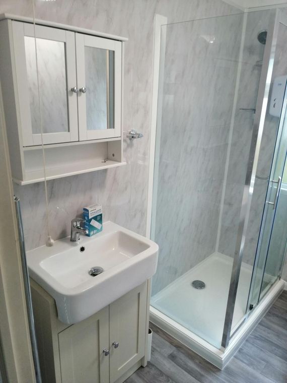 Vanity unit and mirrored cabinet in a shower room