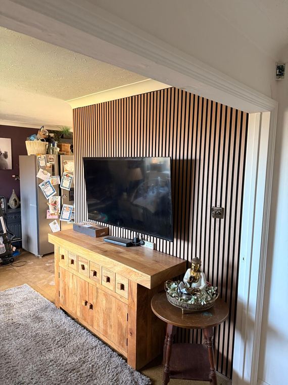 The slatted wall seen from across the room